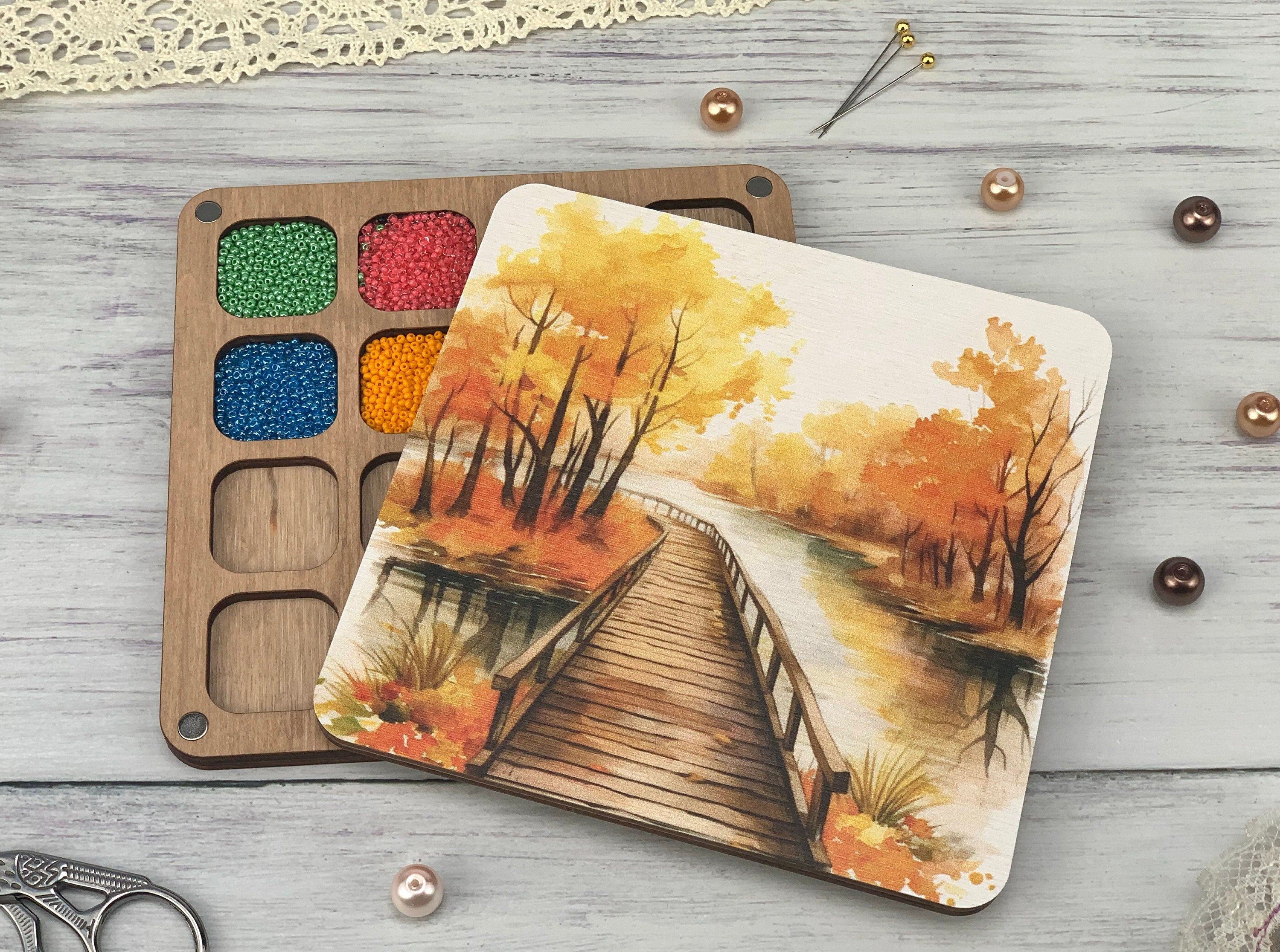 a watercolor painting of a bridge in the woods